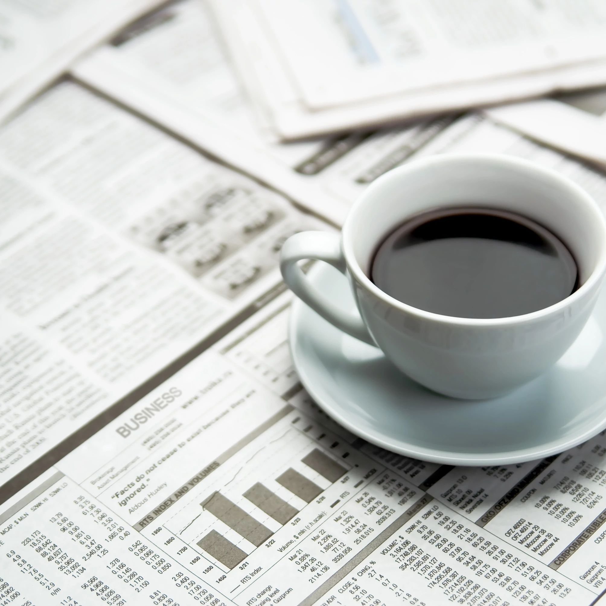 A cup of coffee on a newspaper